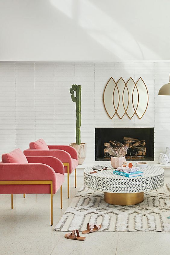 Leo astrology home decor guide | Mid-century modern living room pink armchairs gold accents round table living room | Girlfriend is Better