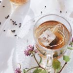 Afternoon Tea | flowers in filled teacup on wood slab | Girlfriend is Better