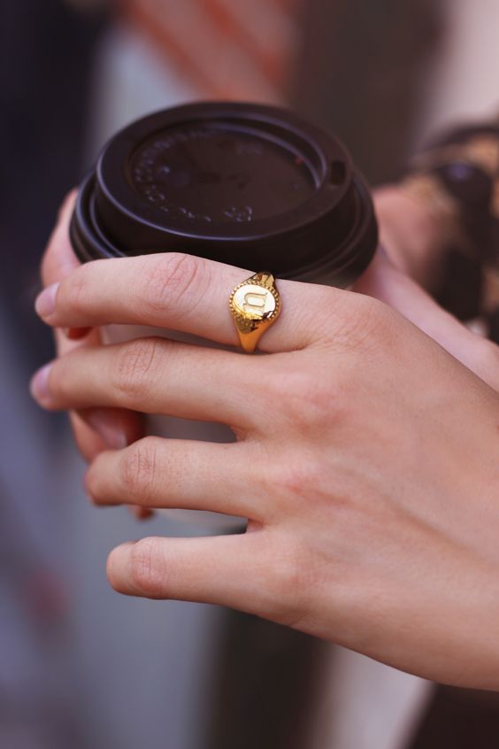 gold signet ring | woman holding coffee | Girlfriend Is Better