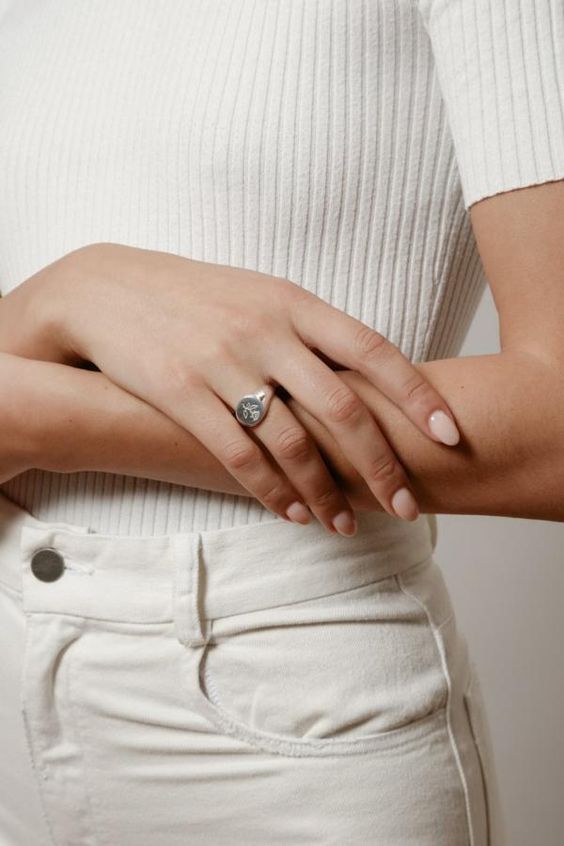 gold signet ring | chic woman with arms crossed | Girlfriend Is Better