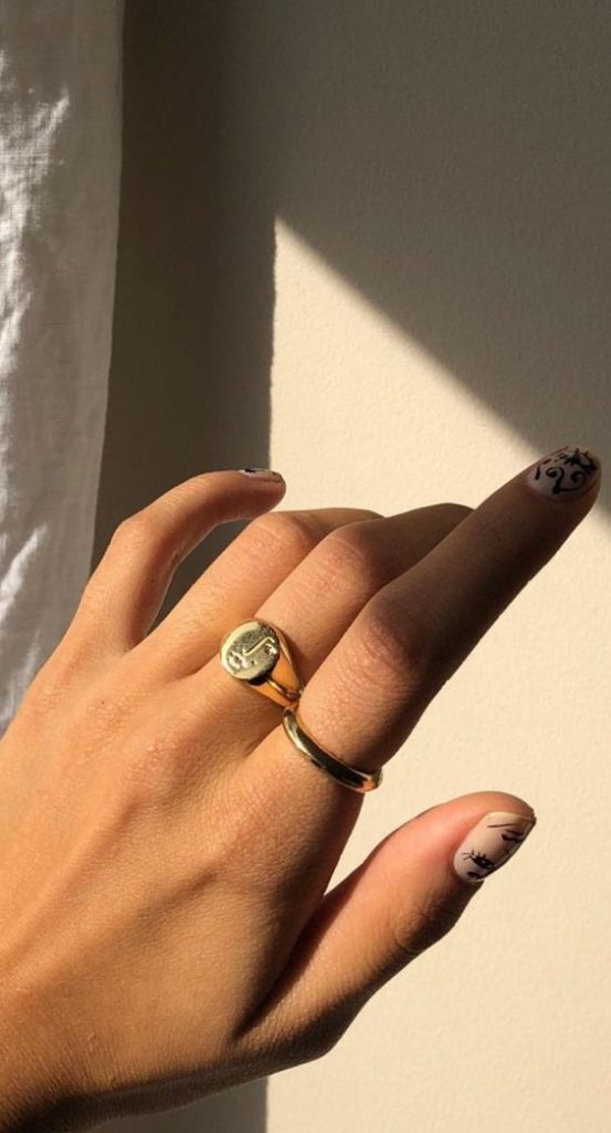 gold signet ring | sun shining on tan hand | Girlfriend Is Better