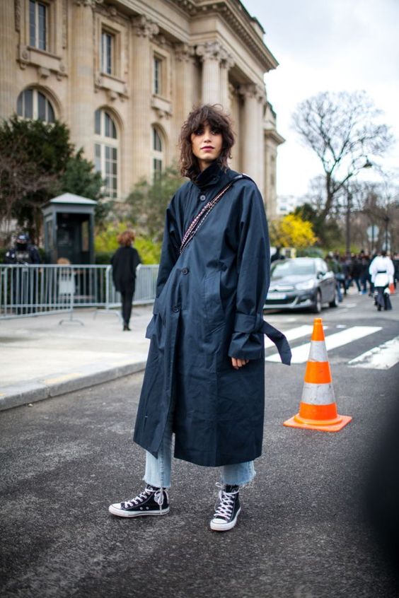 tomboy fashion | black trench coat curly bob hair style high-water jeans Converse | Girlfriend is Better