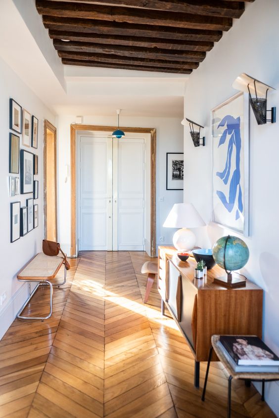 herringbone wood floors | entryway Breuer style bench caned console table abstract art | Girlfriend is Better