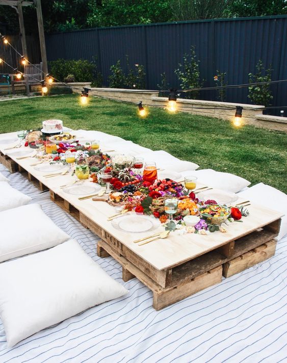 Spring picnic | backyard party patio string lights pillows pallets | Girlfriend is Better