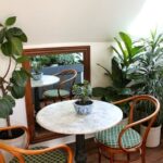 bistro tables | French country horseshoe rattan chairs marble | Girlfriend is Better