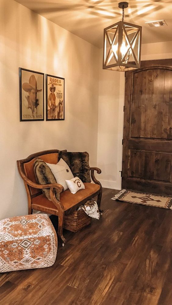 Southwestern decor | Girlfriend is Better | rustic entryway vintage Western posters leather bench wood flooring